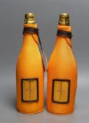 Two bottles of Veuve Cliquot champagne with ice jackets