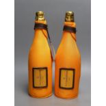 Two bottles of Veuve Cliquot champagne with ice jackets