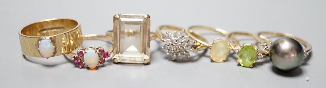 Seven assorted modern 9ct gold and gem set dress rings, including diamond cluster, white opal and