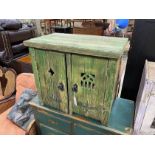 A small Gothic style painted pine two door cupboard, width 66cm, depth 41cm, height 57cm