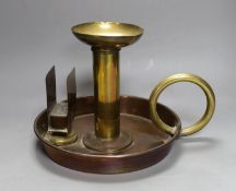 A large brass and copper chamberstick by G Farris, London, 20cm