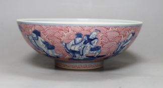 A Chinese underglaze blue and puce enamelled 'eight immortals' bowl, 22cm diameter