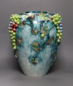 A large late 19th/early 20th century Continental polychrome glazed ‘grape vine’ vase, 39cm tall