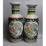 A near pair of Chinese black ground rouleau vases. 47.5cm high