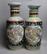 A near pair of Chinese black ground rouleau vases. 47.5cm high