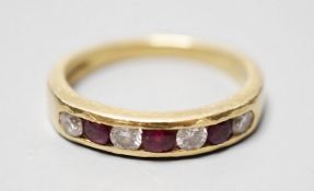 A modern 18ct gold and channel set four stone diamond and three stone ruby set half hoop ring,