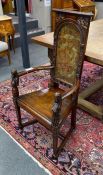 A 20th century carved mahogany cacqueteuse (armchair) with painted leather panelled back, width