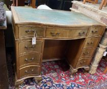 A reproduction George III style mahogany serpentine shaped kneehole desk, length 97cm, width 55cm,