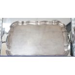 A George V silver two handled tea tray, with wavy border, Joseph Gloster Ltd, Birmingham, 1928, 56.