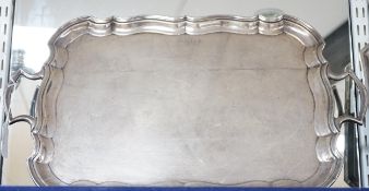 A George V silver two handled tea tray, with wavy border, Joseph Gloster Ltd, Birmingham, 1928, 56.