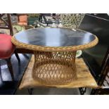 An oval ebonised rattan conservatory table, width 100cm, height 56cm