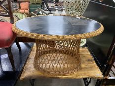 An oval ebonised rattan conservatory table, width 100cm, height 56cm