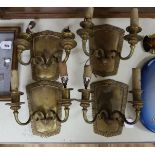 A set of four brass wall sconces