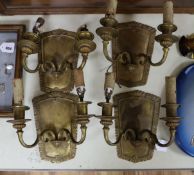 A set of four brass wall sconces