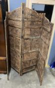 An Indian carved hardwood four fold screen, largest panel width 50cm, height 184cm