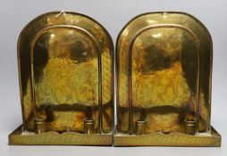 A pair of Arts and Crafts Dutch style brass candle wall sconces, 31cm tall