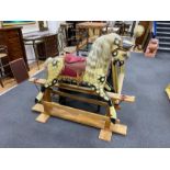 A mid 20th century Ayres type dapple rocking horse on pine safety frame height 122 cms