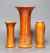 A group of three Ruskin orange lustre vases, largest 25cm
