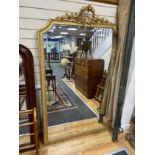 A late 19th century French Louis XVI style giltwood and composition overmantel mirror with floral