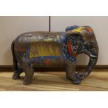 A large painted Indian hardwood elephant. 63cm wide