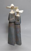 A Lladro stoneware group of two nuns, 34 cm high, boxed