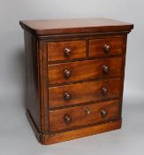 A Victorian miniature chest with five drawers and a key, 38cm tall