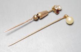 An early 20th century yellow metal, ruby, diamond and cultured pearl cluster set stick pin, 58mm and