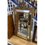 A French giltwood and composition overmantel mirror with floral cherub pediment width 91cm, height