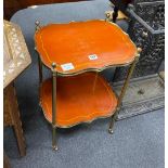 A French painted mahogany and brass two tier etagere of oval serpentine form, width 40cm, depth