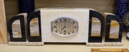 An Art Deco onyx and marble clock garniture, The clock 43 cm wide