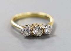 A modern 18ct gold and three stone set diamond ring, size K/L, gross weight 3 grams.