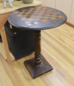 A stained pine inlaid chessboard top table, 75cm high, 56cm diameter and a set of Staunton chess