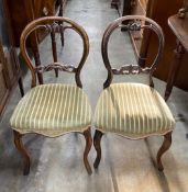 A set of four Victorian balloon back dining chairs