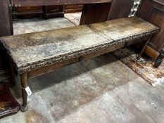 An 18th century and later carved oak hall bench with twin hinged box seat, width 183cm, depth