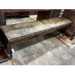 An 18th century and later carved oak hall bench with twin hinged box seat, width 183cm, depth