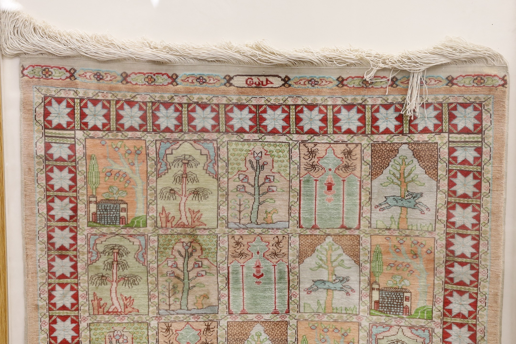 An Eastern framed silk rug depicting trees amimals and buildings, 86 cms high x 67cms wide - Image 2 of 4