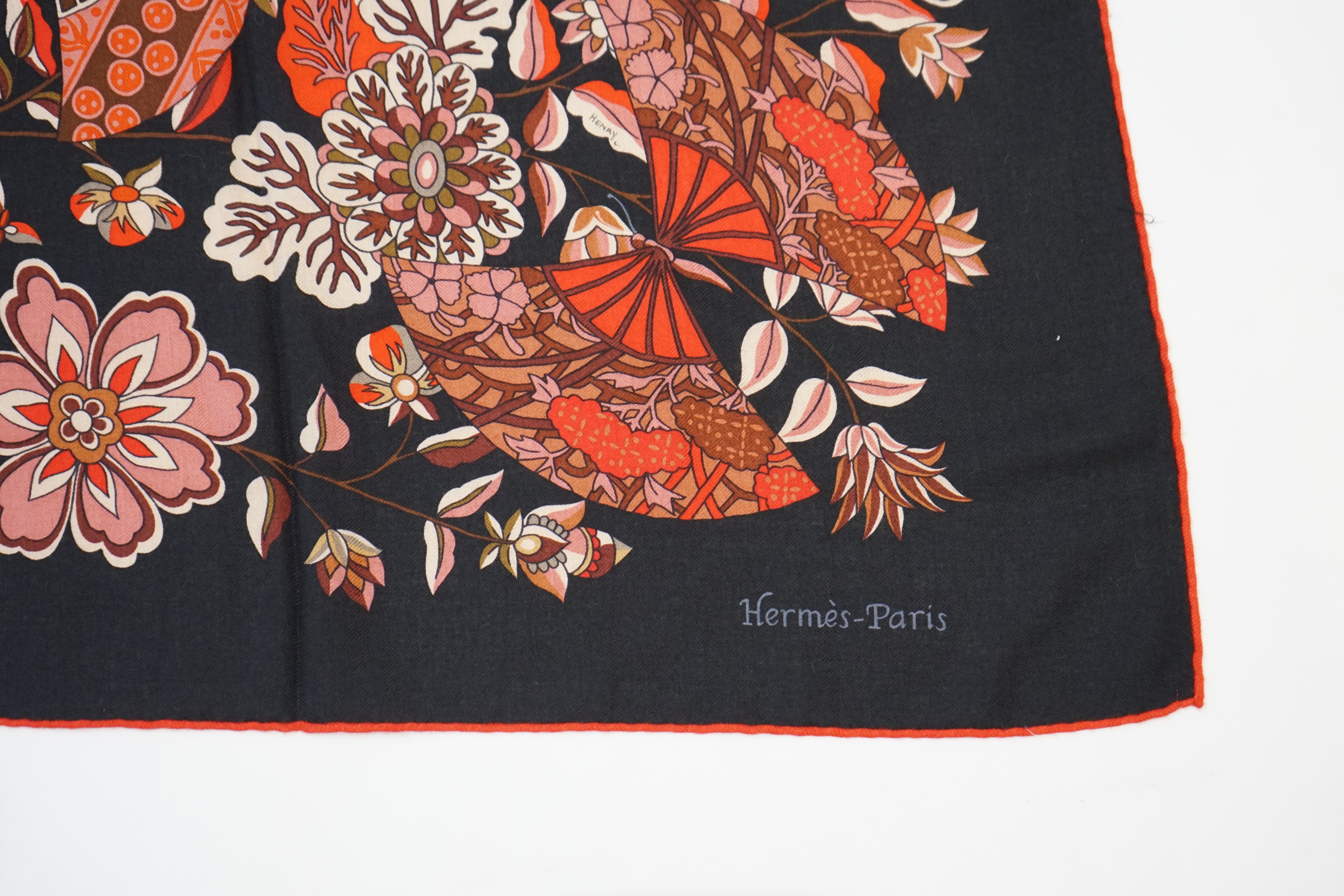 An Hermes wool scarf, with fan and flower motifs on a black ground, in Hermes cloth bag 132 cm. - Image 2 of 6