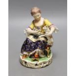 A Bloor Derby porcelain figure of a lady feeding a cat with a spoon, c.1820, No. 362, 15cm tall.