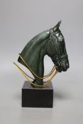 An Art Deco patinated bronze of a horses head on black marble base, 23cms high