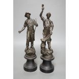 A pair of spelter blacksmith figures, tallest 34cms high