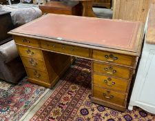 An Edwardian oak pedestal desk, width 138cm