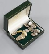 A pair of modern silver oval cufflinks and two other pairs of cufflinks.