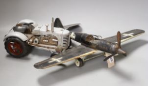 A German tinplate Focke-Wulf model aeroplane, 62cm wingspan, and a tinplate model tractor