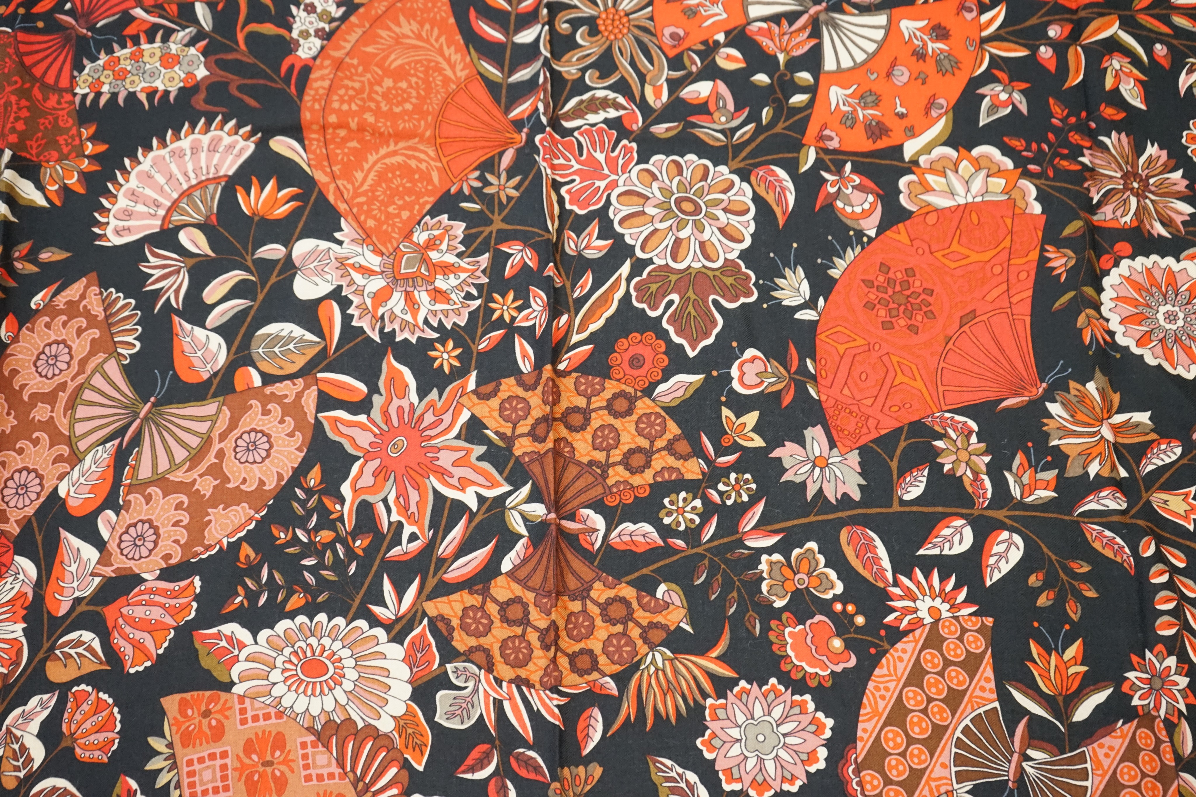 An Hermes wool scarf, with fan and flower motifs on a black ground, in Hermes cloth bag 132 cm. - Image 3 of 6