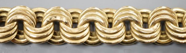 A yellow metal interwoven circular link bracelet, 21cm, 37.6 grams.