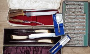 Two cased plated carving sets, a cased set of silver handled cake knives, a modern silver handled