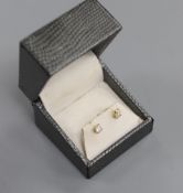 A pair of 18kt and solitaire diamond set ear studs, gross weight 1.2 grams. the total diamond weight