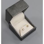 A pair of 18kt and solitaire diamond set ear studs, gross weight 1.2 grams. the total diamond weight