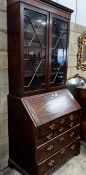 A George III mahogany bureau, with later bookcase top, width 96cm, depth 57cm, height 225cm