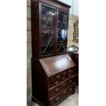 A George III mahogany bureau, with later bookcase top, width 96cm, depth 57cm, height 225cm